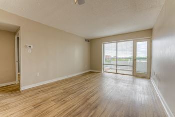 A room with wooden flooring and a ceiling fan.